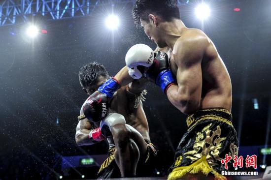 资料图：昆仑决比赛中，21岁的中国选手孔令丰(右)挑战“泰拳王子”播求。 陈骥旻 摄