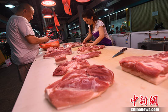 8月9日，山西太原，民众在菜市场选购猪肉。中新社记者 武俊杰 摄