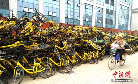 Shared bikes are piled along a road in Beijing. (Photo/China News Service)