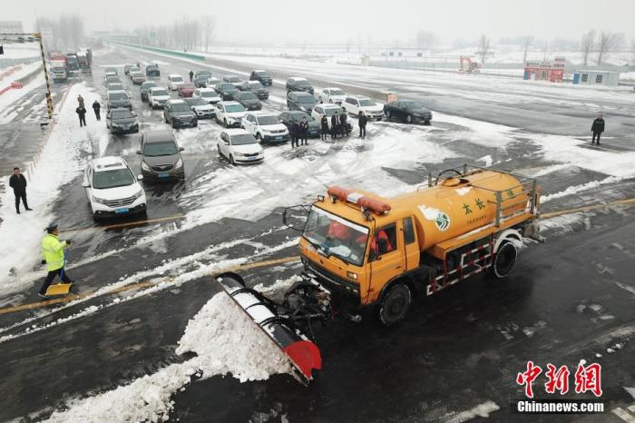 资料图：高速公路工作人员清理积雪，保障道路恢复通行。<a target='_blank' href='http://www.chinanews.com/'>中新社</a>记者 韦亮 摄