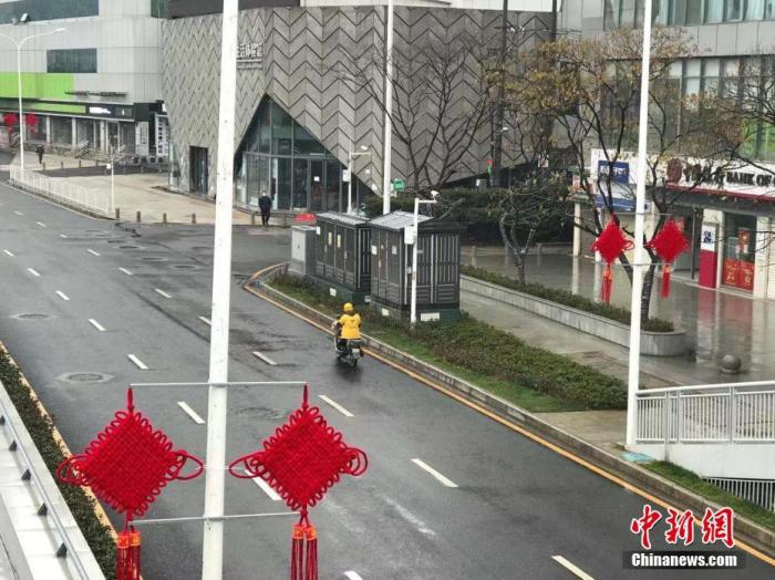 1月26日，农历大年初二，湖北武汉市一位外卖小哥在送餐途中。中新社记者 裴春梅 摄