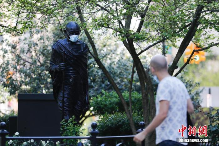 当地时间5月3日，有人为纽约联合广场的甘地雕塑戴上口罩，引起许多路人注目。据美国约翰斯·霍普金斯大学发布统计数据，截至3日晚，美国累计新冠肺炎确诊病例已经超过115万例。
<a target='_blank' href='http://www.chinanews.com/'>中新社</a>记者 廖攀 摄