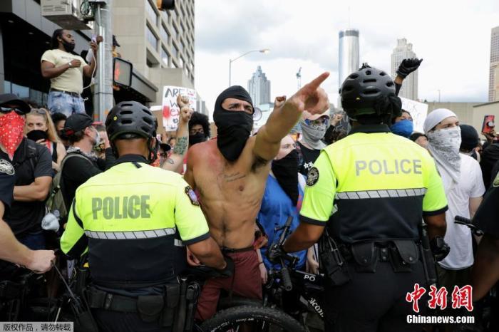 图为当地时间5月29日，亚特兰大的美国有线电视新闻网(CNN)总部外，警察和抗议者发生冲突。