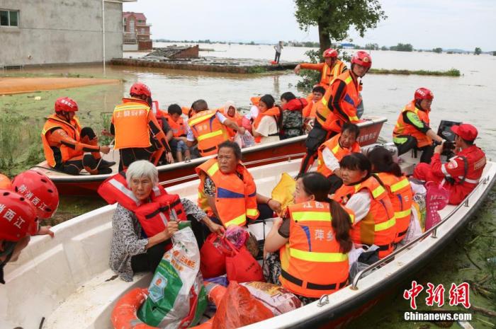 资料图：民众搭乘冲锋舟有序离开被洪水围困的村庄。 刘力鑫 摄