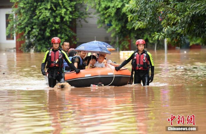 8月12日，四川眉山，消防员在洪水中用橡皮艇转移被困民众。中新社记者 刘忠俊 摄