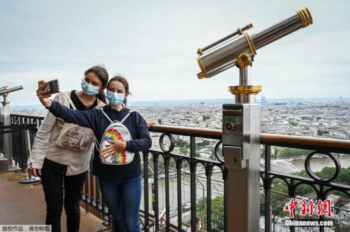 图为游客在埃菲尔铁塔上合影留念。