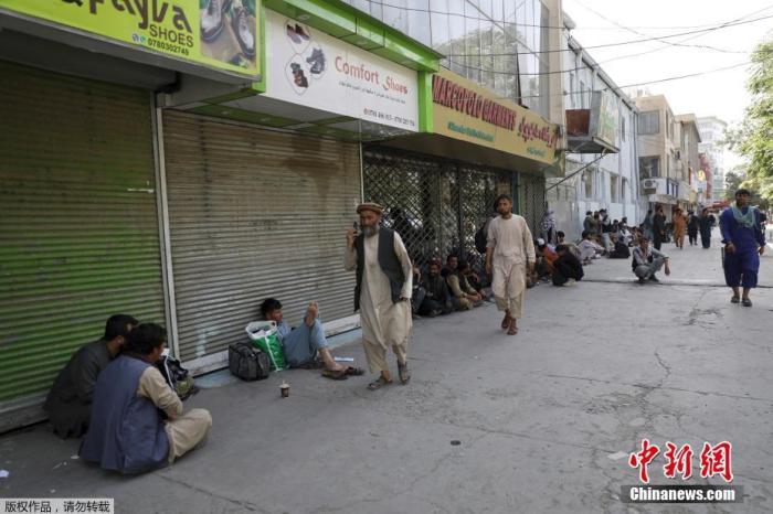 当地时间8月15日，阿富汗首都喀布尔，民众在一个集市排队，等待从附近银行取钱。阿富汗塔利班发言人当天宣布，塔利班武装人员已进入首都喀布尔。