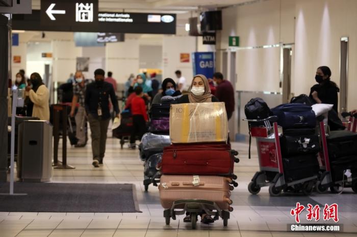 当地时间9月7日，加拿大多伦多皮尔逊国际机场，刚入境的国际旅客准备走出航站楼。