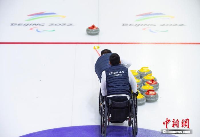 11月22日，中新社記者前往位于北京市順義區的中國殘疾人奧林匹克運動管理中心，探訪中國輪椅冰壺隊在此備戰北京2022年冬殘奧會的情況。北京2022年冬殘奧會將于2022年3月4日開幕。圖為中國隊隊員陳建新與隊友在訓練。 中新社記者 侯宇 攝