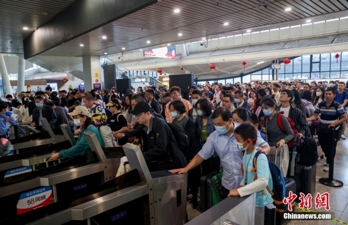 资料图：2023年10月6日，旅客在武汉站进站乘车出行。
中新社
记者 张畅 摄