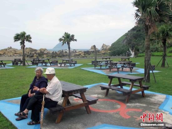 10月21日，中国传统的重阳节。台湾一些老人来到位于基隆的和平岛海角乐园登高望远，享受这里天海一线的海岸景观。和平岛是基隆一个具有浓厚的历史背景且具有异国风情的地方，原来是一个独立海岛，后来兴建的和平桥与基隆相连而成“陆连岛”，由于终年受到东北季风吹袭以及海浪拍打侵蚀影响，形成和平岛的天然奇特景观。蓝天、白云、生态、海洋是和平岛海角乐园的主要元素。中新社记者 任海霞 摄
