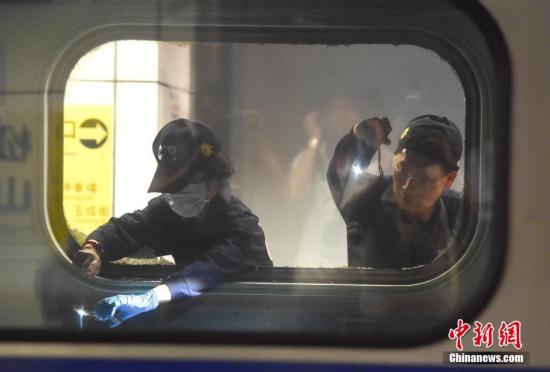 台湾台铁1258次区间车7月7日晚10时行驶到台北市松山车站时发生爆炸起火，24名乘客遭受轻重伤。图为警员在爆炸现场提取证据。 中新社记者 徐冬冬 摄
