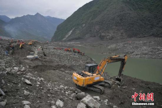 6月25日，大型机械在垮塌现场作业。 中新社记者 刘忠俊 摄