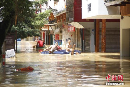 7月2日，因连日暴雨，位于珠江上游的融江河水猛涨，导致广西柳州市融水苗族自治县县城一半城区被泡，街道成河，居民只得乘船出行。朱柳融 摄