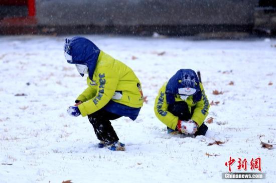 西安迎2018年初雪，小朋友在玩雪。王晓凯 摄