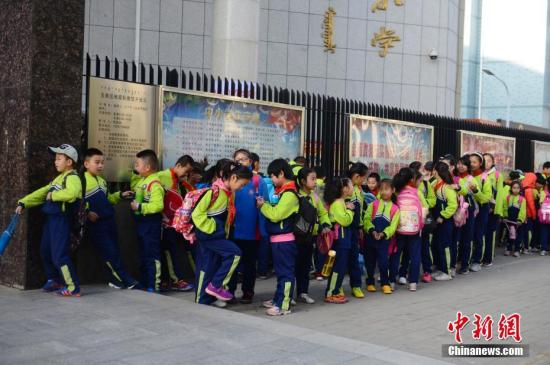 资料图：小学生排队等待进入校园。中新社记者 刘文华 摄