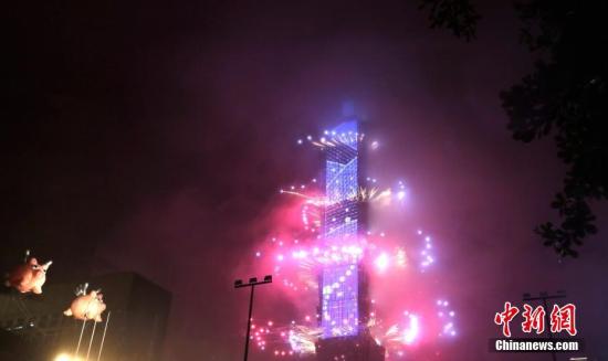 2019年1月1日零时，数以万计的台湾民众与海内外游客冒雨在台北信义区观赏101大楼烟火表演，迎来新年。中新社记者 刘舒凌 摄