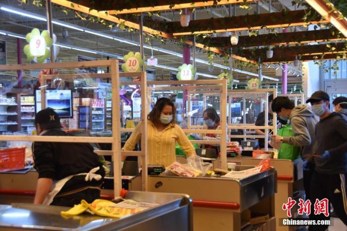 当地时间4月6日，大华府地区的一家超市在结账区收银员和顾客之间设置玻璃隔断，防止互相传染。
中新社记者 沙晗汀 摄